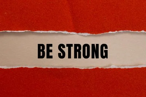 Be Strong message written on ripped torn paper background. Conceptual Be St.. Foto stock