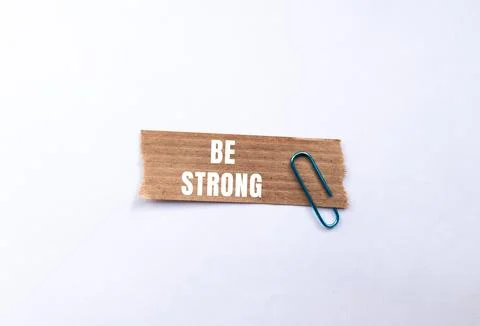 Be Strong message written on ripped torn paper background. Conceptual Be St.. Stock Photos