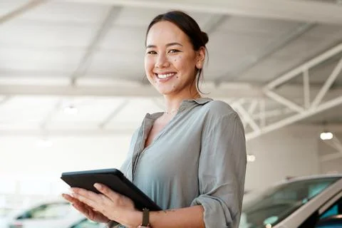 Be sure to make the right choice. a woman using her digital tablet in a car Stock Photos