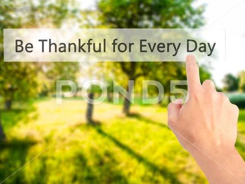 Be Thankful for Every Day - Hand pressing a button on blurred ba Stock Photos
