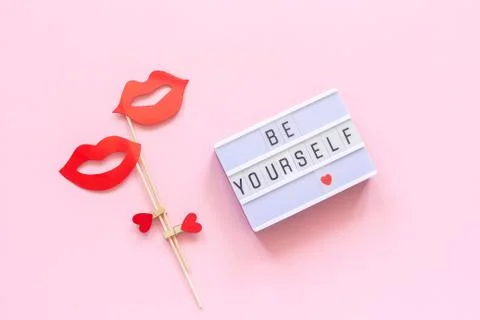 Be yourself Lightbox text, couple paper lips props on pink background. Concep Stock Photos
