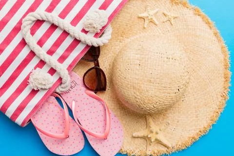 Beach accessories flat lay top view on colored background Summer travel conce Stock Photos