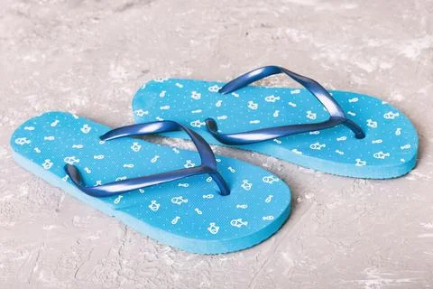 Beach accessories. Flip flops and starfish on colored background. Top view Mo Stock Photos