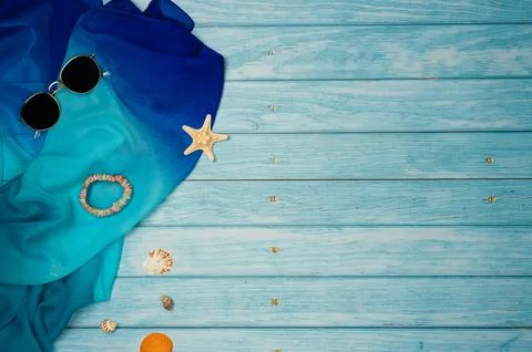 Beach accessories with shells on a blue wooden background. Top view, copy spa Stock Photos