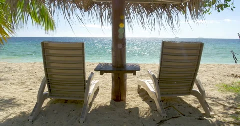 Beach accessories on a white sandy beach overlooking the blue sea  Stock Footage 135145673