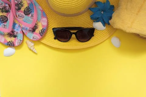 Beach accessories on yellow background with copy space Stock Photos
