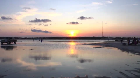 Beach activity over sunset water, static 12fps at 100% Stock Footage 24395141