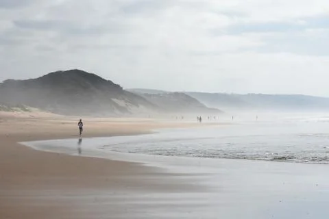 Beach Activity On An Overcast Summer Day Stock Photos