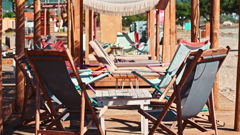 Beach on the aegean coast in Greece. Seats with table, sand Stock Footage 157447637