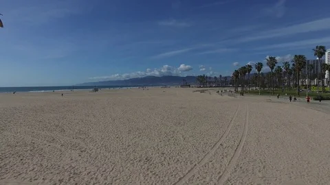 Beach and bike path with mountains Stock Footage