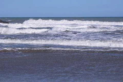 Beach and breaking waves Stock Photos