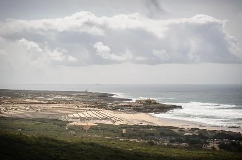 Beach and Ocean View under Cloudy Skies Stock Photos