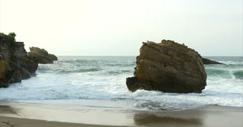 Beach and ocean waves slow motion with surfer Stock Footage 68601483