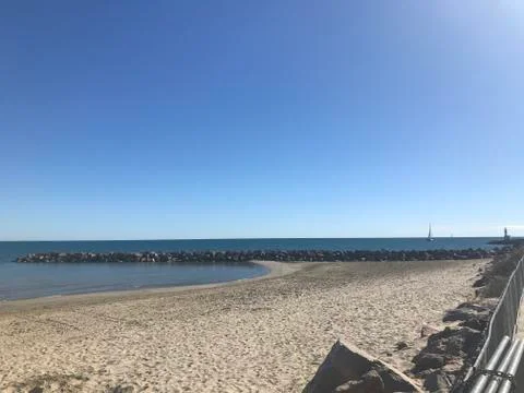 Beach and rock in the distant Stock Photos