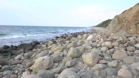 Beach and rocks by cliff Stock Footage 205869756