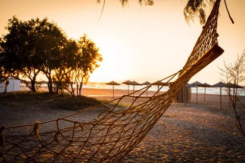 Beach and sea view with empty hammock at sunset Foto stock