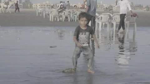 The beach and a small child in Karachi, Pakistan Video stock 343875771