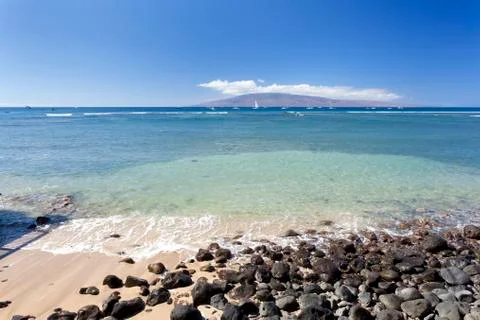 Beach and some rocks with view to Molokai in Lahaina in Maui, Hawaii. Stock Photos