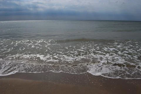 The Beach And Splashing Waves Stock Photos