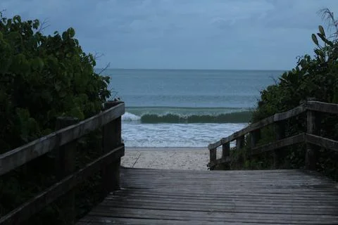 Beach and Wave in a Cloudy Day Stock Photos