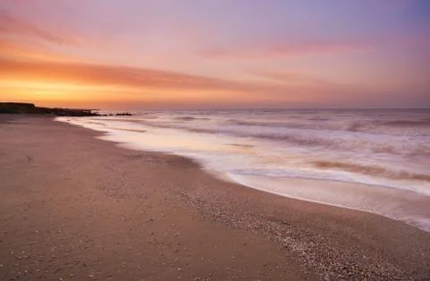 Beach and wave during sunset Stock Photos