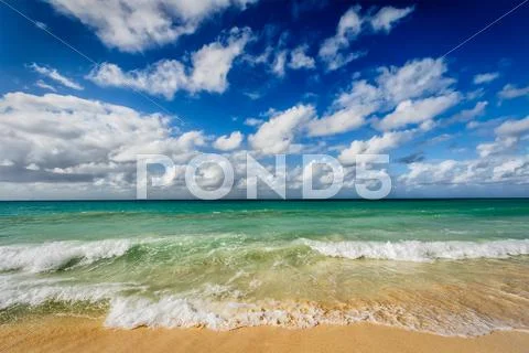 Beach and waves of Caribbean Sea Stock Photos