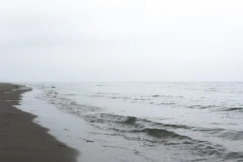 Beach and waves in the mist Stock Photos