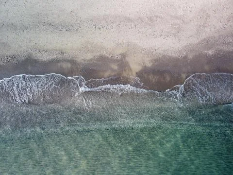 Beach and waves from top view. Turquoise water background from top view. Stock Photos