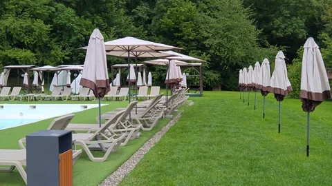Beach area by the pool with sun loungers and umbrellas. Stock Footage 310631914