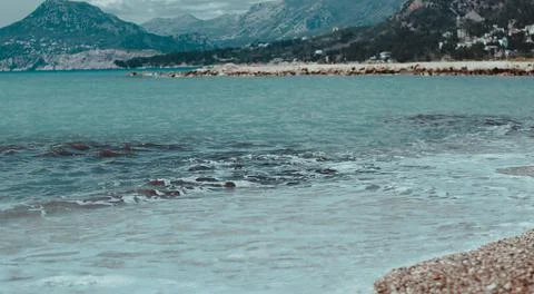 Beach on the background of rocks Stock Photos