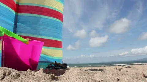 Beach background shot with sand and windbreak and beach toys Video stock 72546520