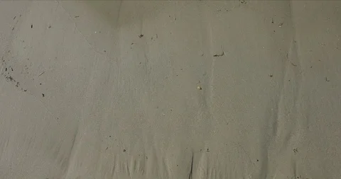 Beach background with water wiping in over the sand from above - 4K 50P. Stock Footage 87848729
