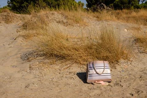 A beach bag lies on the beach Stock Photos
