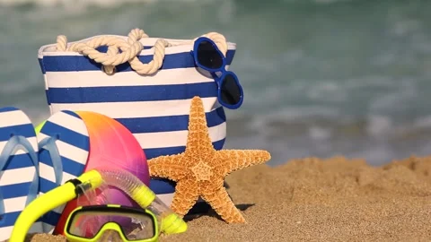 Beach bag is standing on yellow sand against sea. Slow motion Stock Footage 334922279