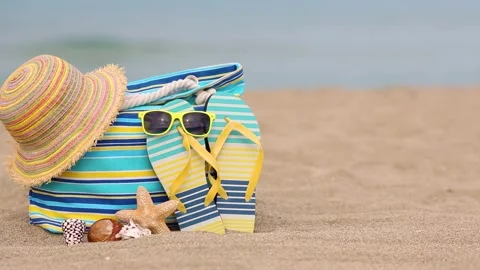 Beach bag is standing on yellow sand against sea. Slow motion Stock Footage 335765034