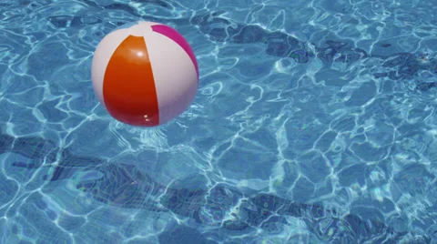 Beach ball floating in pool Stock Footage 36634944