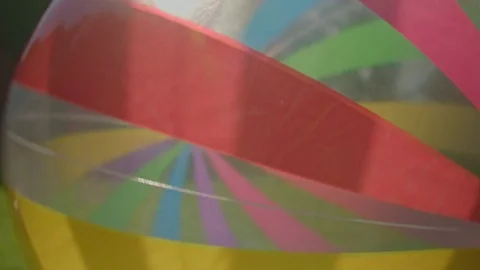 Beach ball rolling in contre-jour - handheld - slow motion 03/03 Stock Footage 80757126