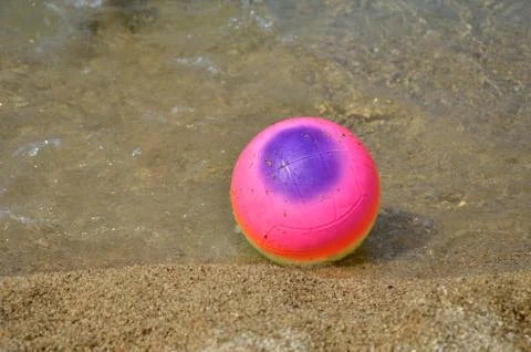 Beach Ball in Shallow Sea Water Stock Photos
