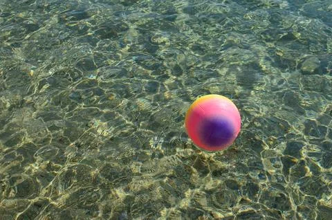 Beach ball on the surface of the water Stock Photos