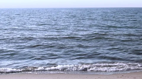 Beach on the baltic coast. Sunny day. Closeup of small sea waves. Horizon, sky. Stock Footage 155140697