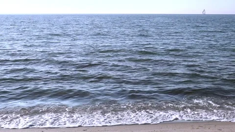 Beach on the baltic coast. Sunny day. Closeup of small sea waves. Horizon, sky. Stock Footage 155140699