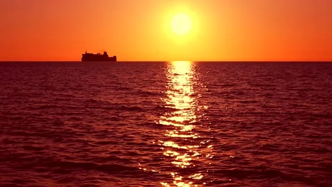 Beach on baltic sea at sunset. Sparkling sea water. Ocean waves with ship. Stock Footage 155183806