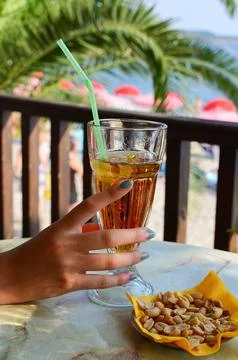 Beach bar refreshing, ice tea and peanuts Stock Photos