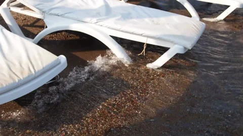 Beach beds, lapped by the sea waves Stock Footage 30556499