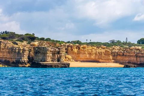 Beach between eroded rock cliffs in the Algarve,Portugal. Stock Photos