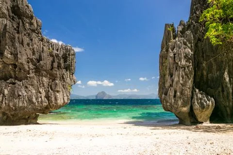 Beach between tall rocks Stock Photos