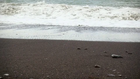 Beach of black sand and storm wave slow mo Stock Footage 82655826