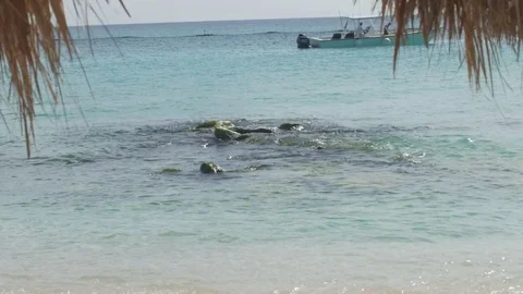 Beach With Boat and Rocks Stock Footage 73560063