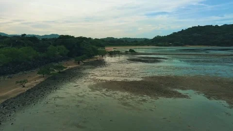 A beach with a body of water in the background Stock Footage 325885816
