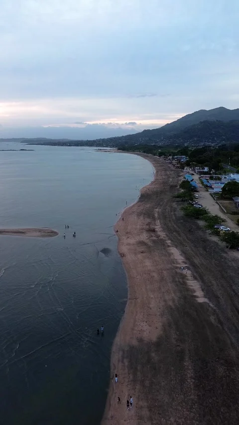 A beach with a body of water in the background Stock Footage 326960754